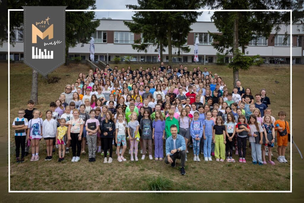 zdjęcie grupowe - dzieci, młodzież i opiekunowie; w centralnej części Adam Sztaba.
